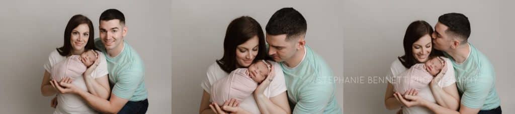 parent poses with newborn baby girl