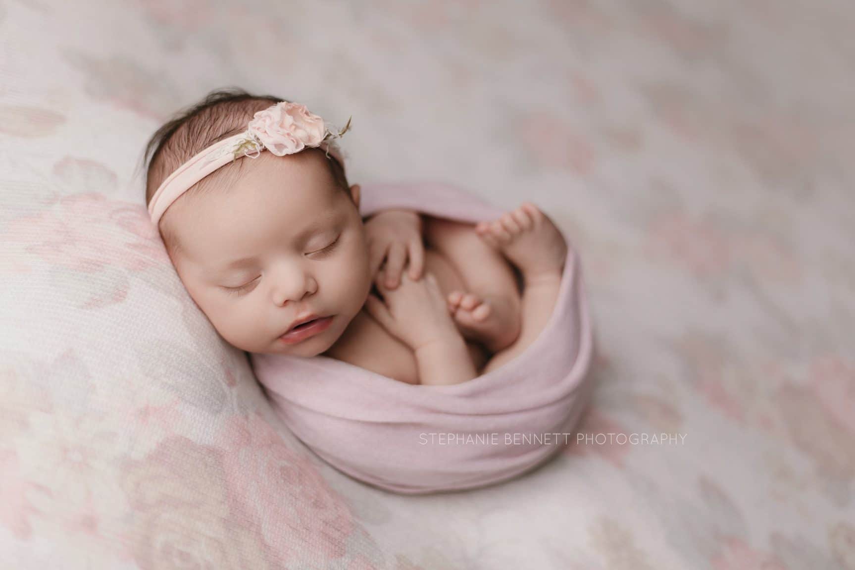 most popular newborn poses with swaddled baby