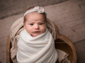 most popular newborn poses with swaddled baby